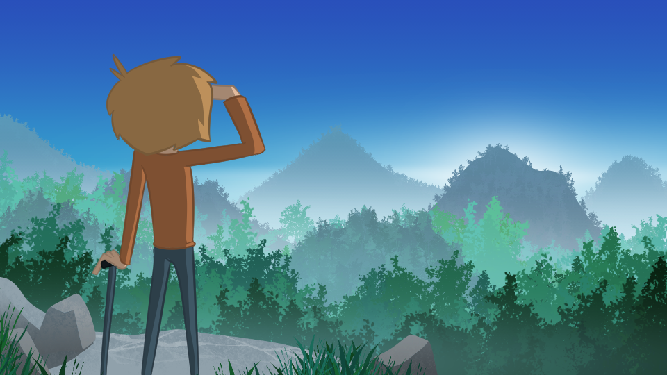 The young man with a walking stick is standing at the top of the mountain staring off into the distance at other, taller mountains